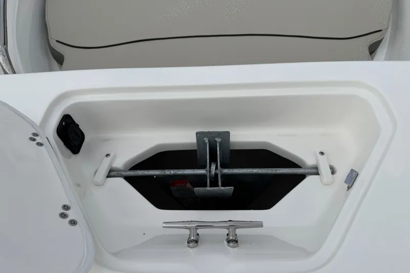 Slide: The Image of Anchor storage compartment on 2026 Key West 189 FS boat, featuring secure latch and cleat. - 9
