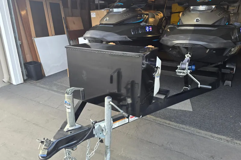 Slide: The Image of 2016 GTX Sea-Doo Limited jet skis on trailer in garage setting. - 3