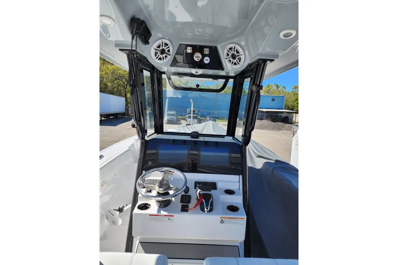 Slide: The Image of 2023 Sportsman Heritage 261 Center Console boat interior with steering wheel and controls. - 4