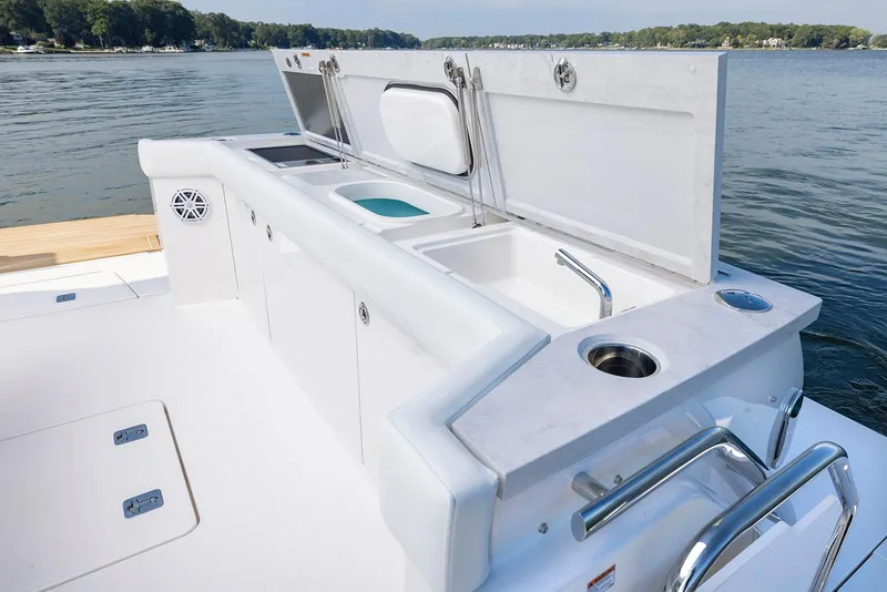 Slide: The Image of Manufacturer Provided Image: 2026 Tiara Yachts EX 60 deck with outdoor kitchen and sink by the water. - 11