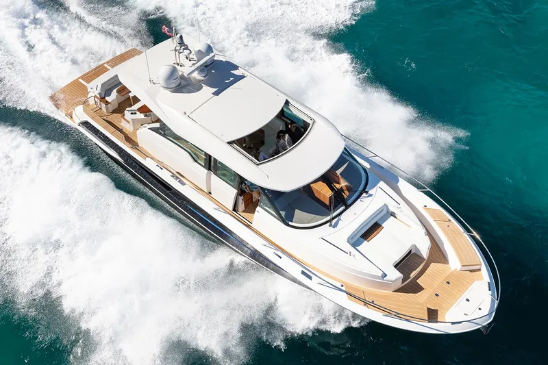 Slide: The Image of Manufacturer Provided Image: 2026 Tiara Yachts EX 60 cruising on clear blue water, showcasing sleek design and luxury. - 2