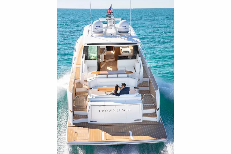 Slide: The Image of Manufacturer Provided Image: 2026 Tiara Yachts EX 60 cruising on open water, rear view with deck seating. - 4