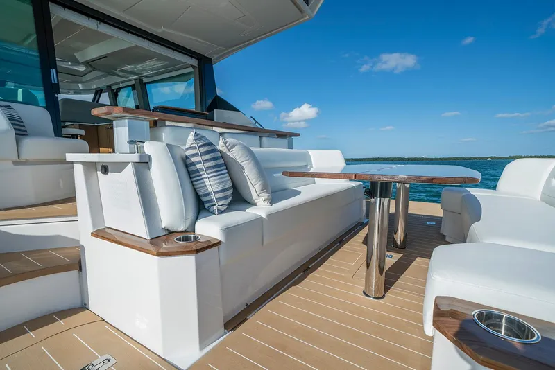 Slide: The Image of Manufacturer Provided Image: 2026 Tiara Yachts EX 60 deck with seating, table, and ocean view. - 9