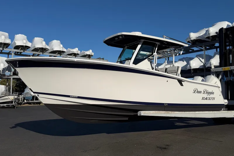 The Image of 2023 Blackfin 272 CC boat in storage, side view, clear sky background. - 1