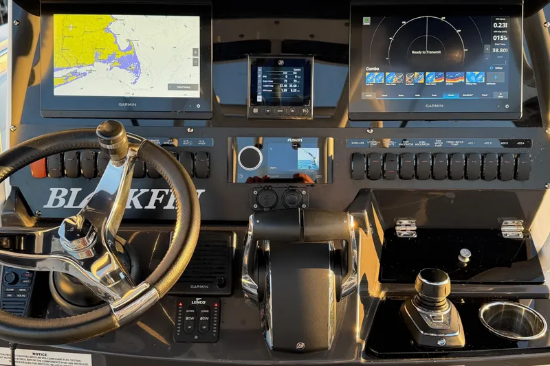 Slide: The Image of 2023 Blackfin 272 CC dashboard with Garmin navigation displays and controls. - 13
