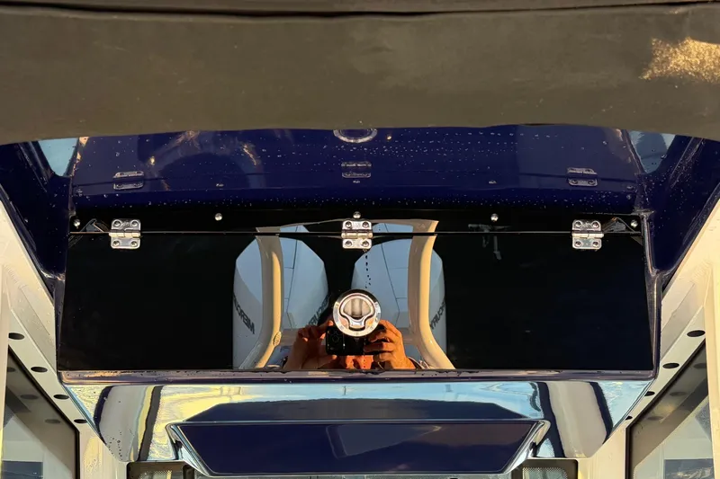 Slide: The Image of 2023 Blackfin 272 CC boat dashboard with reflective surface and control panel. - 15
