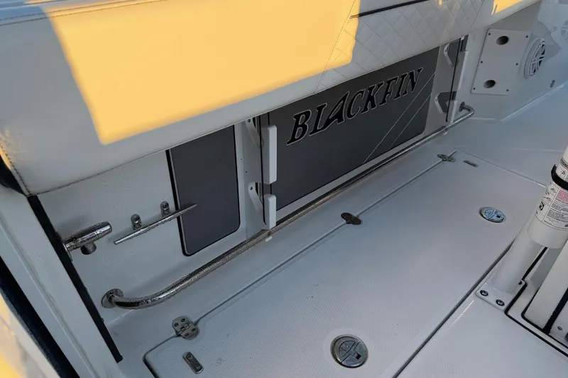 Slide: The Image of 2023 Blackfin 272 CC boat interior with logo and storage compartments. - 21