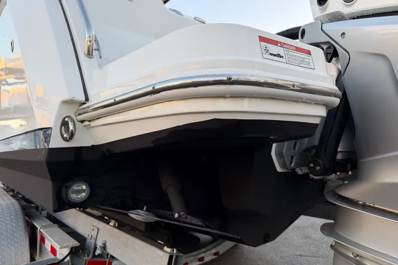 Slide: The Image of 2023 Blackfin 272 CC boat stern detail with warning label and motor components. - 30