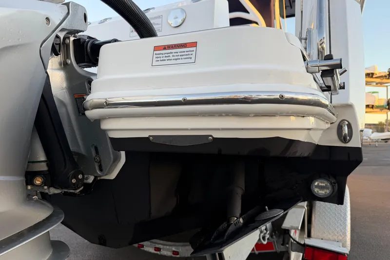 Slide: The Image of 2023 Blackfin 272 CC boat engine detail with warning label and propeller. - 31