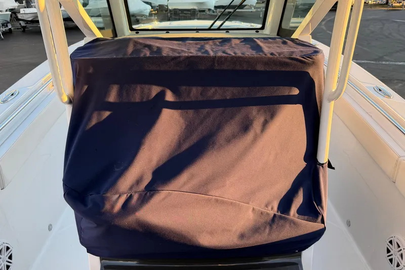 Slide: The Image of 2023 Blackfin 272 CC boat console covered with a navy blue fabric. - 34
