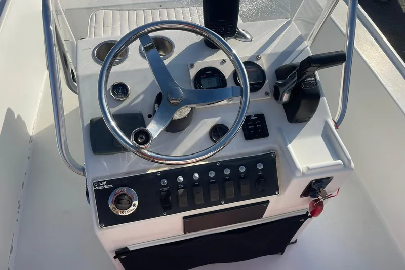 Slide: The Image of 1974 Mako 1701 Inshore boat console with steering wheel and controls. - 12