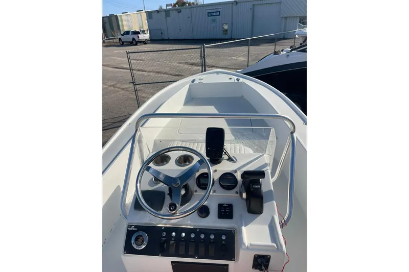 Slide: The Image of 1974 Mako 1701 Inshore boat dashboard with steering wheel and controls. - 8