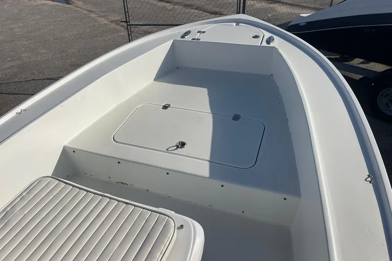 Slide: The Image of 1974 Mako 1701 Inshore boat deck with storage compartment and seating. - 9