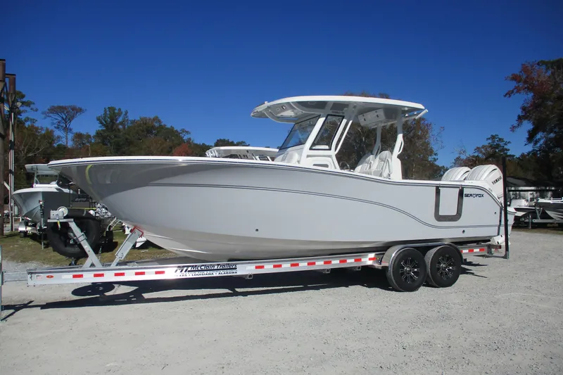 Slide: The Image of 2026 Sea Fox 288 Commander boat on trailer under clear blue sky. - 0