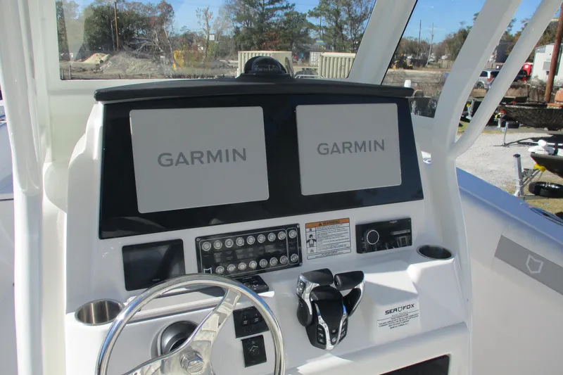 Slide: The Image of 2026 Sea Fox 288 Commander dashboard with dual Garmin displays and controls. - 10