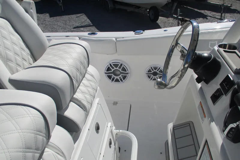 Slide: The Image of 2026 Sea Fox 288 Commander boat interior with steering wheel and cushioned seating. - 11