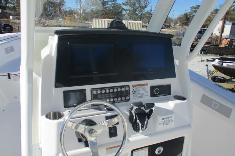 Slide: The Image of 2026 Sea Fox 288 Commander boat dashboard with dual screens and controls. - 7