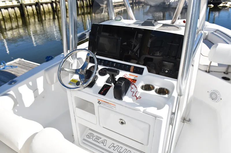 Slide: The Image of 2018 Sea Hunt Ultra 225 boat console with steering wheel and controls. - 22