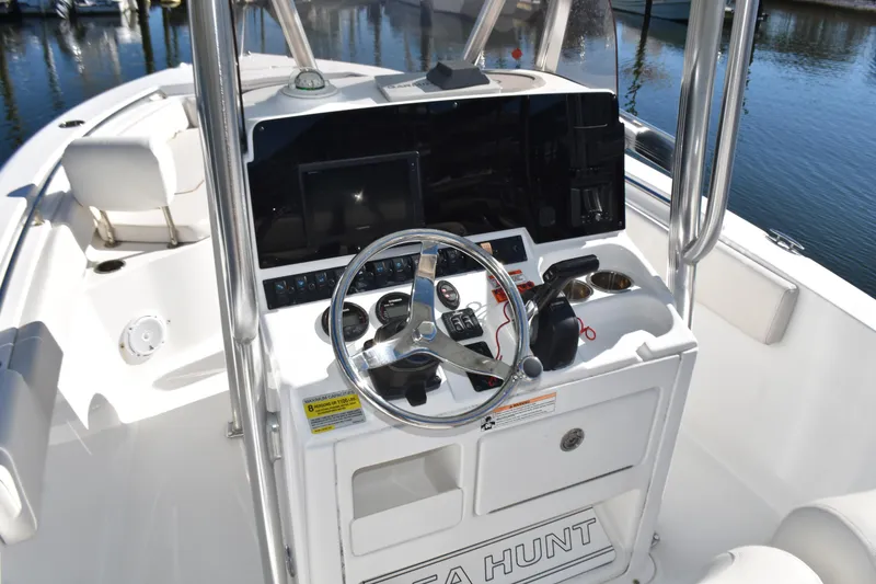 Slide: The Image of 2018 Sea Hunt Ultra 225 boat console with steering wheel and controls. - 23