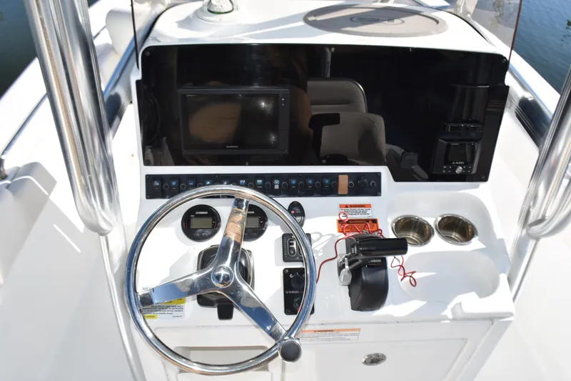 Slide: The Image of 2018 Sea Hunt Ultra 225 boat dashboard with steering wheel and controls. - 24