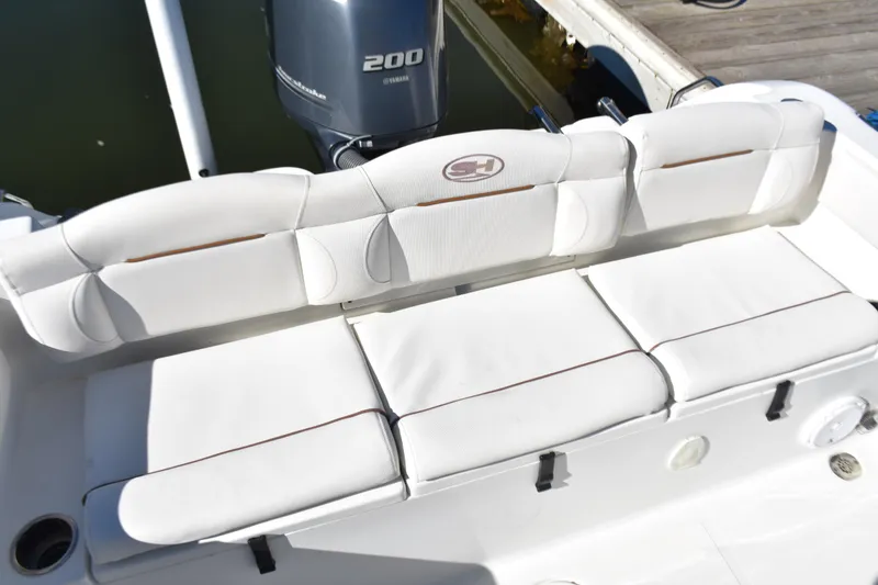 Slide: The Image of 2018 Sea Hunt Ultra 225 boat with white cushioned seating and Yamaha 200 engine. - 26