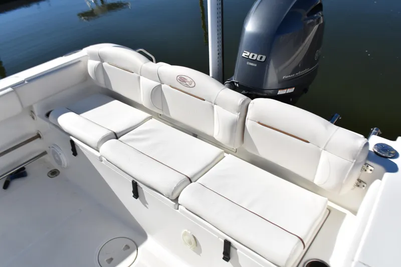 Slide: The Image of 2018 Sea Hunt Ultra 225 boat with Yamaha 200 engine and white cushioned seating. - 27