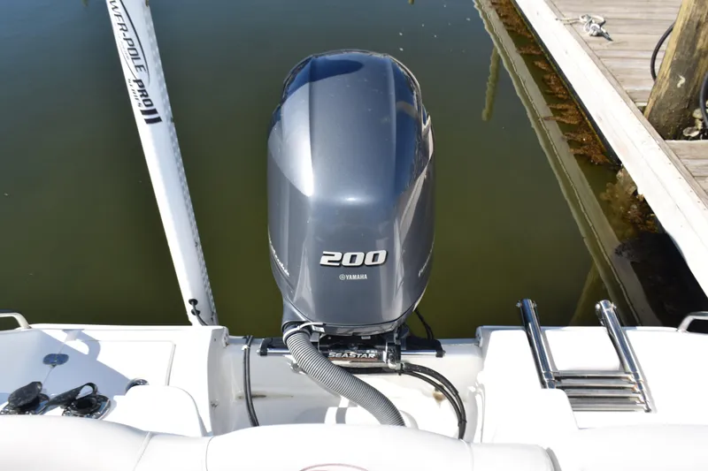 Slide: The Image of 2018 Sea Hunt Ultra 225 with Yamaha 200 outboard motor at dock. - 29