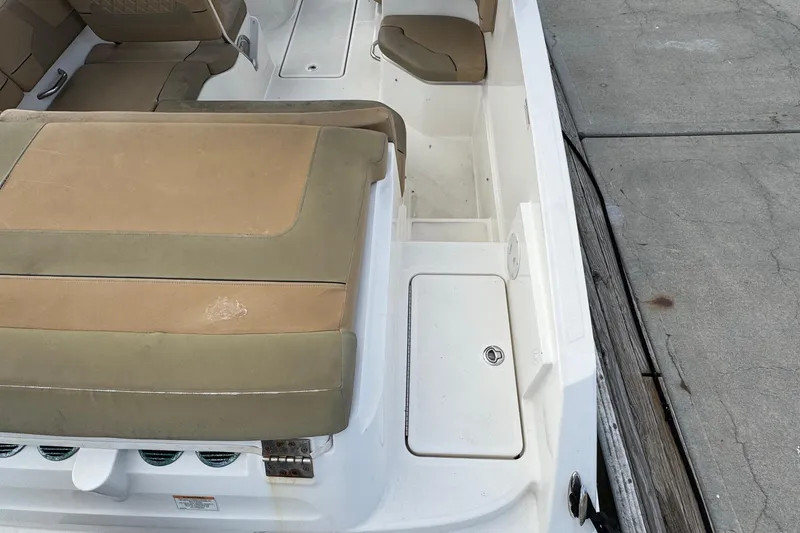 Slide: The Image of 2022 Bayliner VR6 Bowrider OB interior with tan seating and storage compartments. - 11