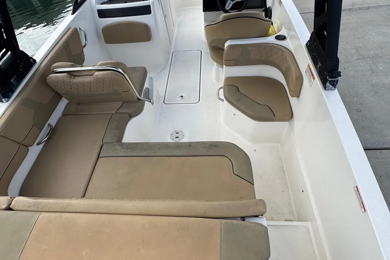 Slide: The Image of 2022 Bayliner VR6 Bowrider OB interior with tan seating and spacious layout. - 12