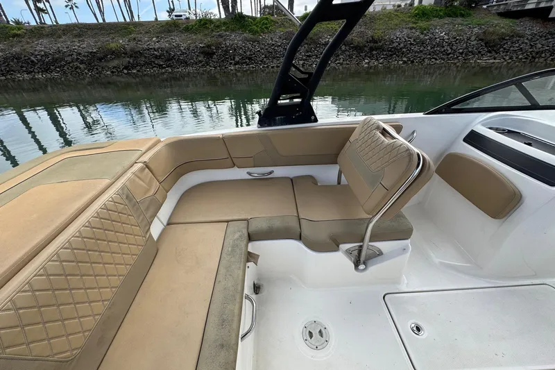 Slide: The Image of 2022 Bayliner VR6 Bowrider OB interior with tan seating and water view. - 18