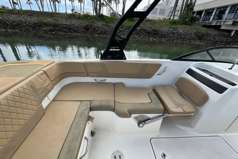 Slide: The Image of 2022 Bayliner VR6 Bowrider OB interior with tan seating and sleek design. - 19