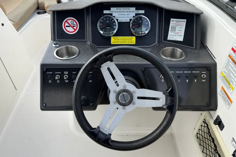 Slide: The Image of 2022 Bayliner VR6 Bowrider OB dashboard with steering wheel and control panel. - 23