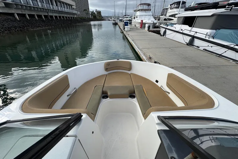 Slide: The Image of 2022 Bayliner VR6 Bowrider OB at marina, featuring spacious bow seating. - 31