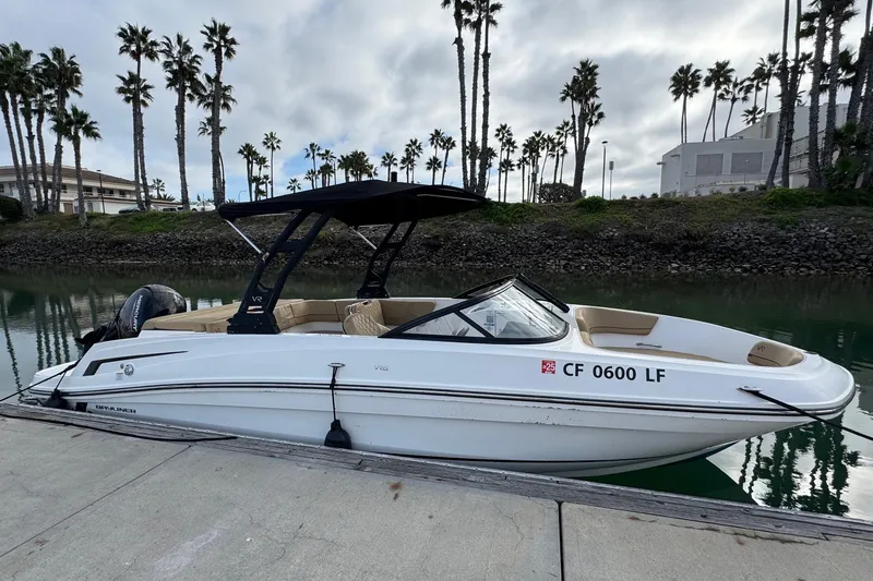 Slide: The Image of 2022 Bayliner VR6 Bowrider OB docked by palm trees, calm water. - 5