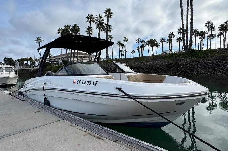 Slide: The Image of 2022 Bayliner VR6 Bowrider OB docked, surrounded by palm trees and calm water. - 7