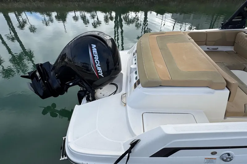 Slide: The Image of 2022 Bayliner VR6 Bowrider OB with Mercury outboard engine on calm water. - 8