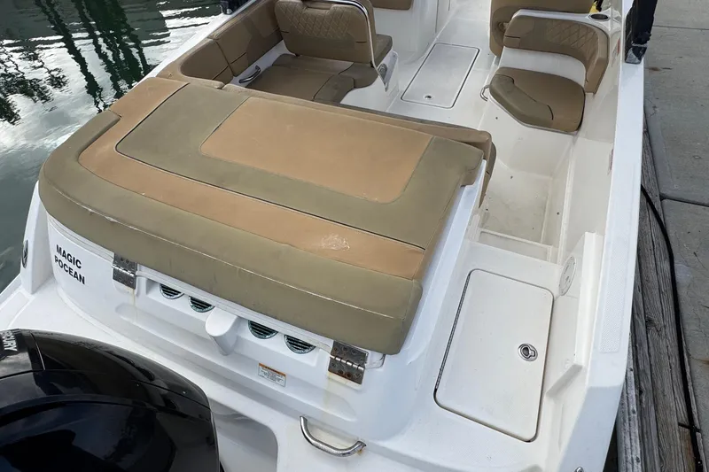 Slide: The Image of 2022 Bayliner VR6 Bowrider OB with tan seating, docked by the water. - 9