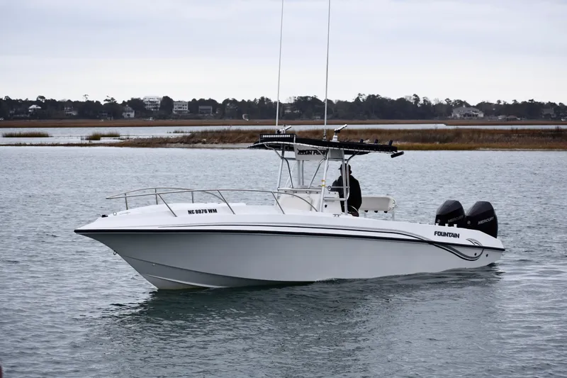 The Image of 2001 Fountain 31 Tournament Edition boat on calm water, featuring twin Mercury engines. - 1