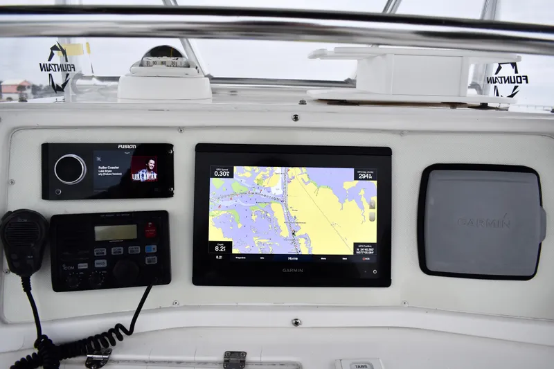 Slide: The Image of 2001 Fountain 31 Tournament Edition boat dashboard with Garmin navigation and audio system. - 22
