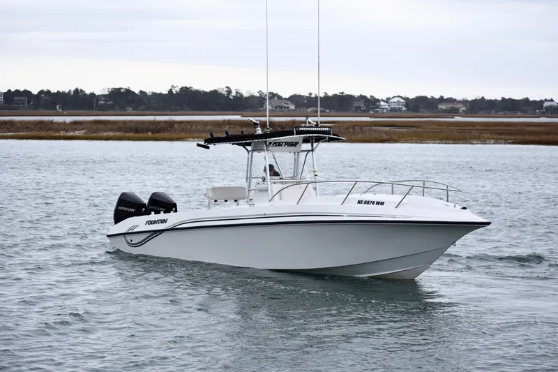 Slide: The Image of 2001 Fountain 31 Tournament Edition boat on calm water, featuring twin Mercury engines. - 8