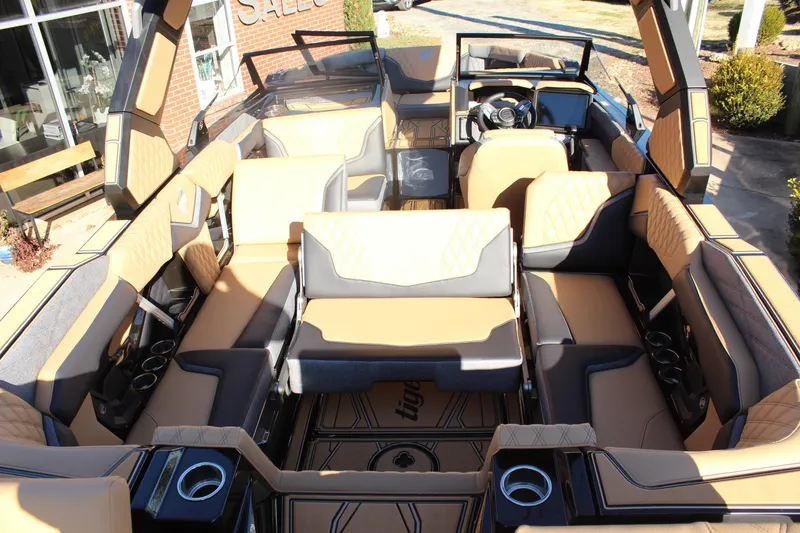 Slide: The Image of 2026 Tigé 24RZX boat interior with luxurious tan and gray seating. - 14
