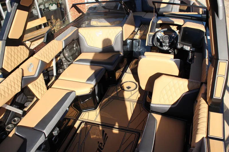 Slide: The Image of Luxurious interior of 2026 Tigé 24RZX boat with tan and black seating. - 15