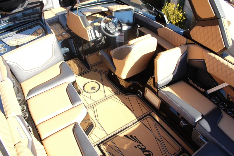 Slide: The Image of Luxurious interior of 2026 Tigé 24RZX boat with tan and black seating. - 16