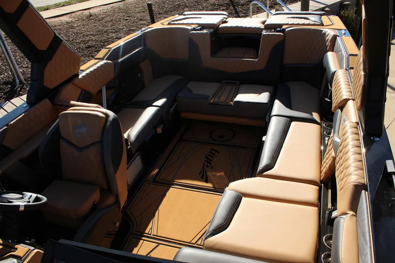 Slide: The Image of Luxurious interior of 2026 Tigé 24RZX boat with tan and black seating. - 17