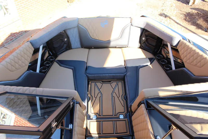 Slide: The Image of Luxurious interior of 2026 Tigé 24RZX boat with tan and black seating. - 19