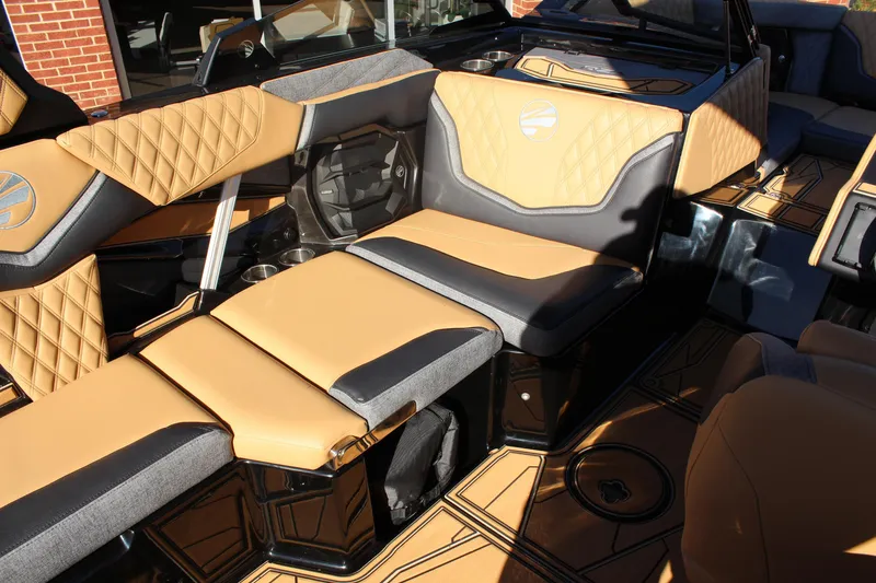 Slide: The Image of Luxurious interior of 2026 Tigé 24RZX boat with tan and black seating. - 26