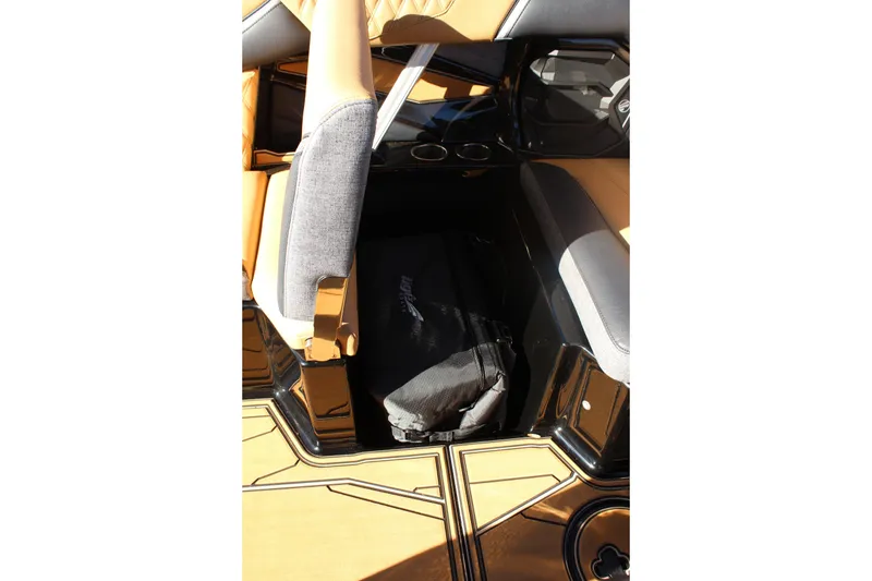 Slide: The Image of 2026 Tigé 24RZX boat interior with tan and gray seating, storage compartment. - 27