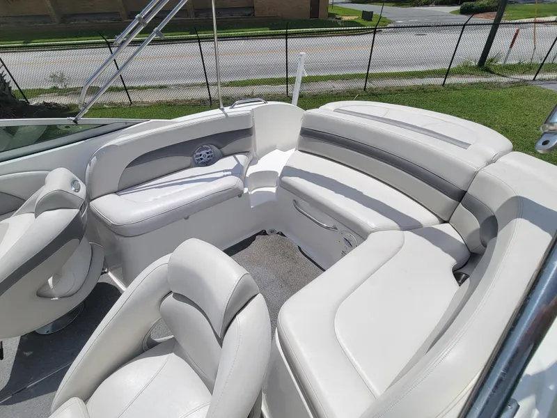 Slide: The Image of 2007 Chaparral Sunesta 214 boat interior with white seating and spacious layout. - 10