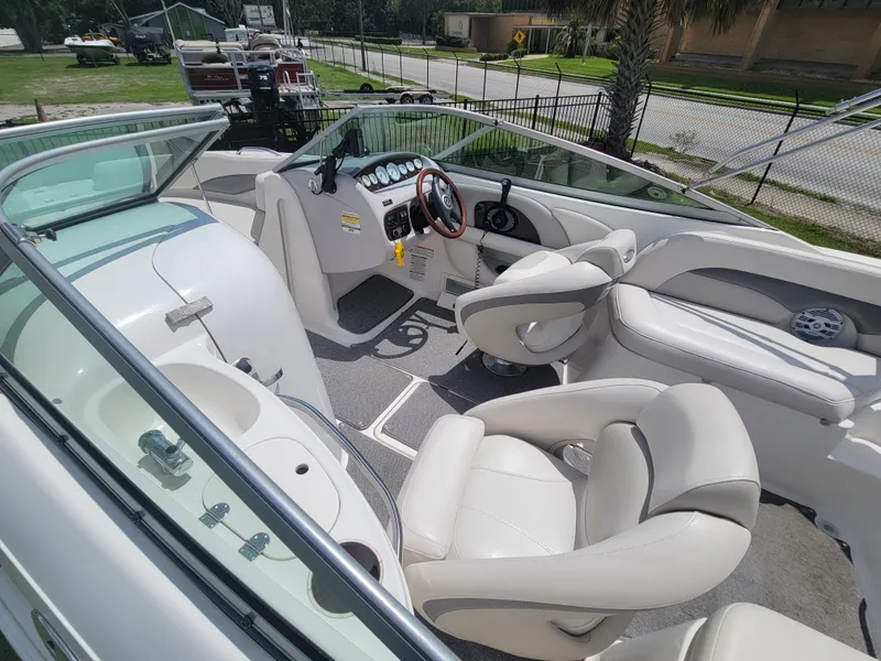 Slide: The Image of 2007 Chaparral Sunesta 214 boat interior with white seating and dashboard. - 11