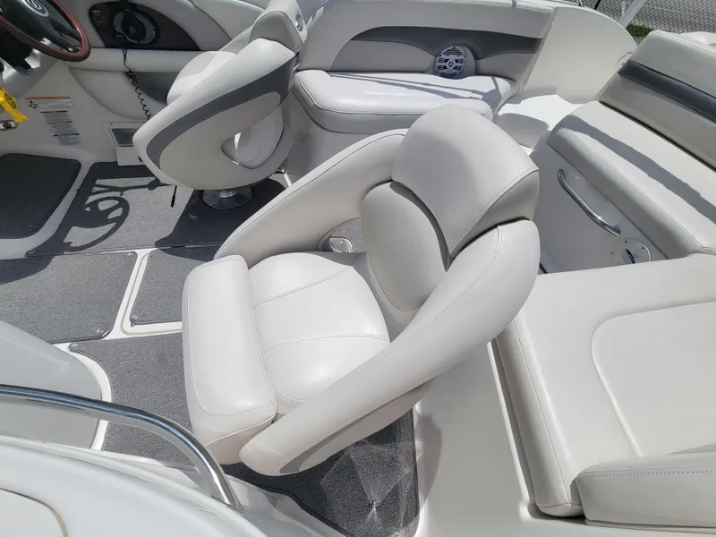 Slide: The Image of 2007 Chaparral Sunesta 214 boat interior with white leather seating and modern design. - 12